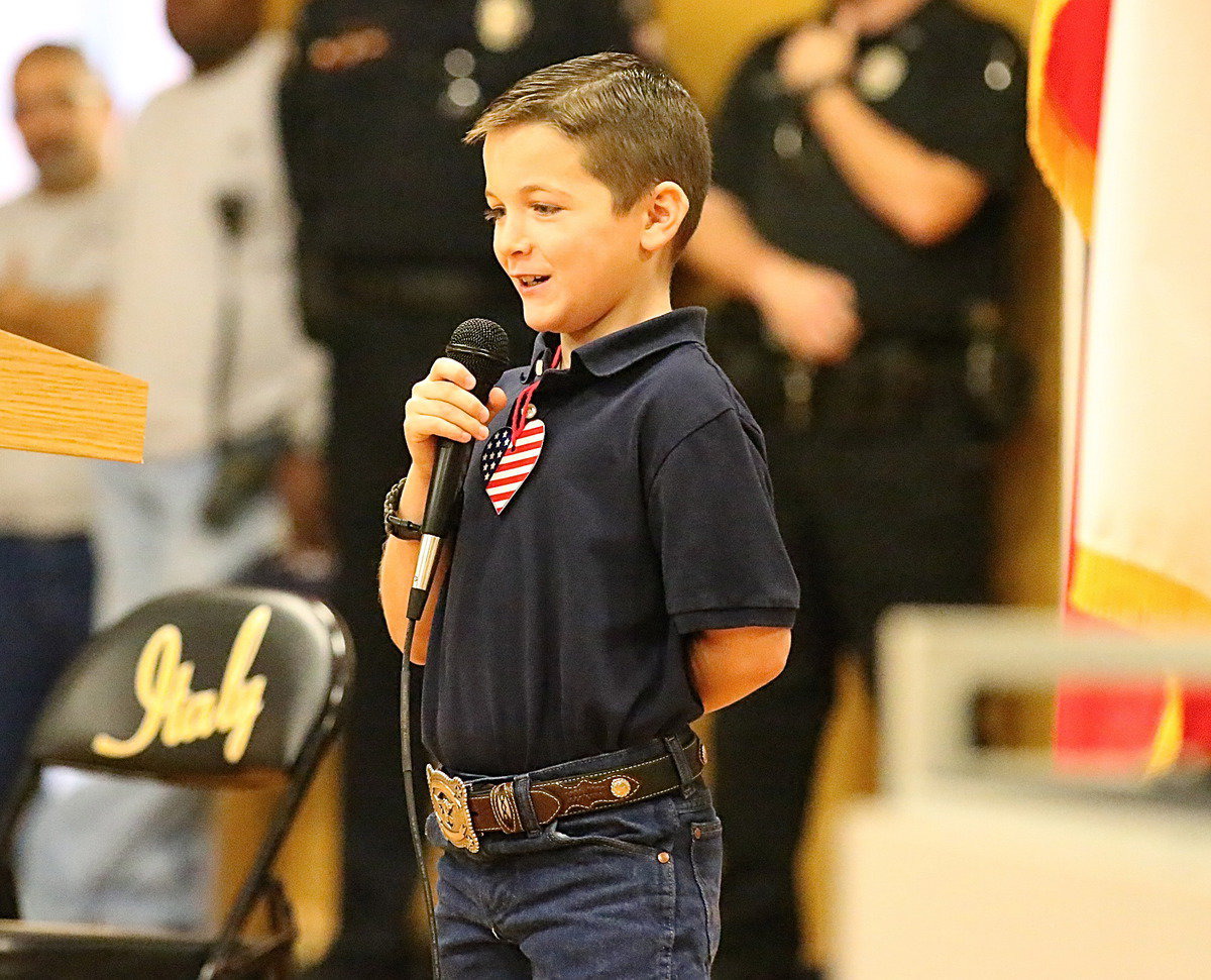 Image: Stafford Elementary student council member, Easton Viator, helps recite a poem for veterans.