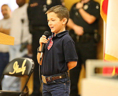 Image: Stafford Elementary student council member, Easton Viator, helps recite a poem for veterans.