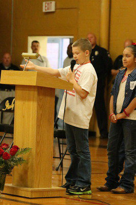 Image: Stafford Elementary student council president, Tanner Chambers, begins reciting a poem to the attending veterans.