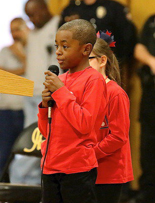 Image: Stafford Elementary student council member, Darrin Jackson, continues the poem to the veterans.