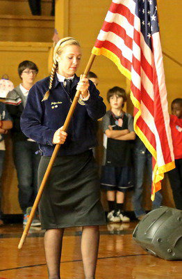 Image: Italy FFA president Jaclynn Lewis sets the United States Flag in place.