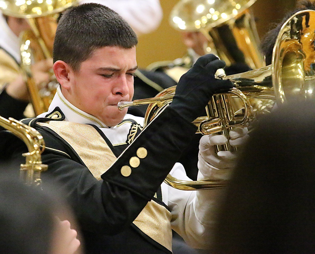 Image: Eli Garcia gives the veterans his all during a playing of Taps.