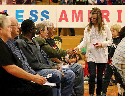 Image: Stafford Elementary student council member, Kimmy Hooker, passes out gifts to veterans.