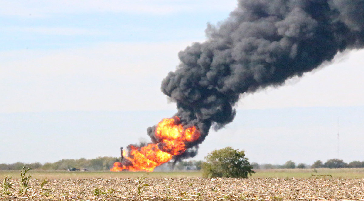Image: The site of the gas explosion rages on after several construction vehicles were engulfed after unintentionally drilling into the line.