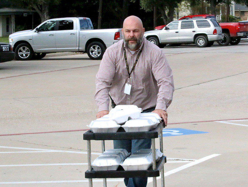 Image: Italy HS Principal Lee Joffre rolls into the dome with donated meals from Hillsboro’s Black-eyed Pea for Milford’s evacuees.