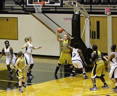 Image: Jaclynn Lewis(13) rebounds the ball and then passes it ahead to teammate Tara Wallis(4).