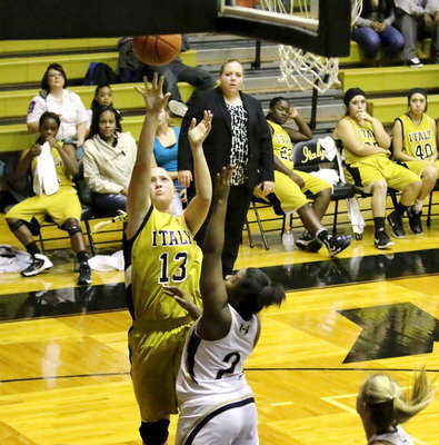 Image: Lady Gladiator head coach Melissa Fullmer observes as Jaclynn Lewis(13) rises for a shot.