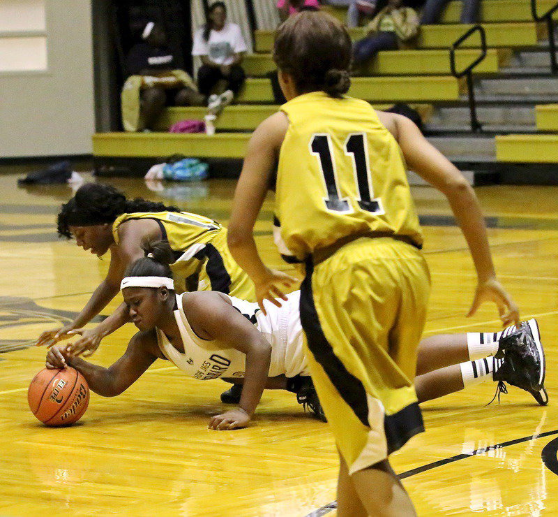 Image: Kendra Copeland(10) and Ryisha Copeland(11) chase after a loose ball.