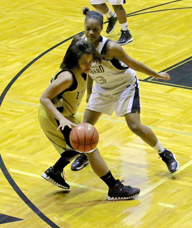 Image: Alex Minton(12) maintains her dribble with a Hubbard defender pressuring the ball.