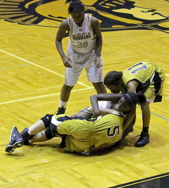 Image: Halee Turner(5) tangles with a Hubbard player for possession of the ball with help from teammate Ryisha Copeland(11).