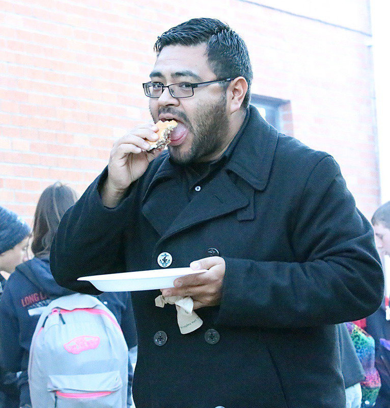 Image: Band director Jesus Perez and one unfortunate burger.