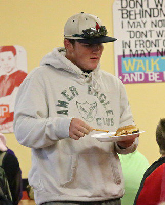 Image: Gladiators have talent. Tyler Vencill eats, walks and socializes without fumbling a french fry.