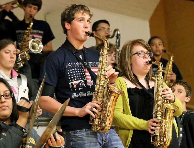 Image: Senior band members JoeMack Pits and Emily Stiles jam along with their band mates during the Senior Night pep rally.