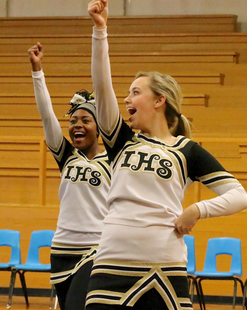 Image: Cheerleaders K’Breona Davis and Kelsey Nelson prepare for the entrance of the Gladiator football team.