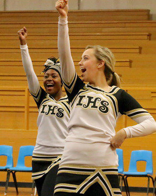 Image: Cheerleaders K’Breona Davis and Kelsey Nelson prepare for the entrance of the Gladiator football team.