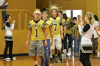 Image: Levi McBride(1), Justin Wood(4) and Ryan Connor(7) lead their Gladiator teammates into the old gym.