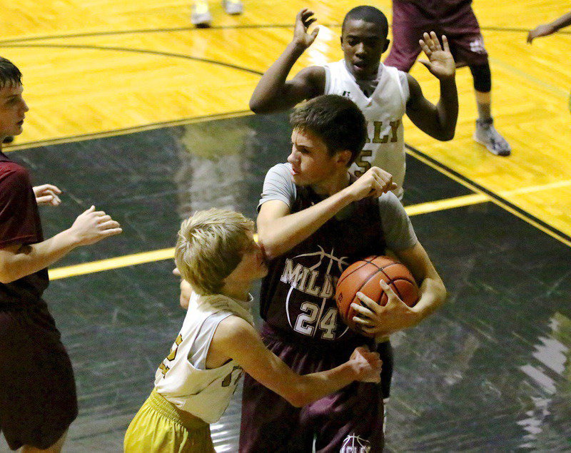 Image: Italy 8th grader Garrett Janek(12) takes a viscous and deliberate elbow and then gets shoved to the ground. The Mildred player was ejected from the game.