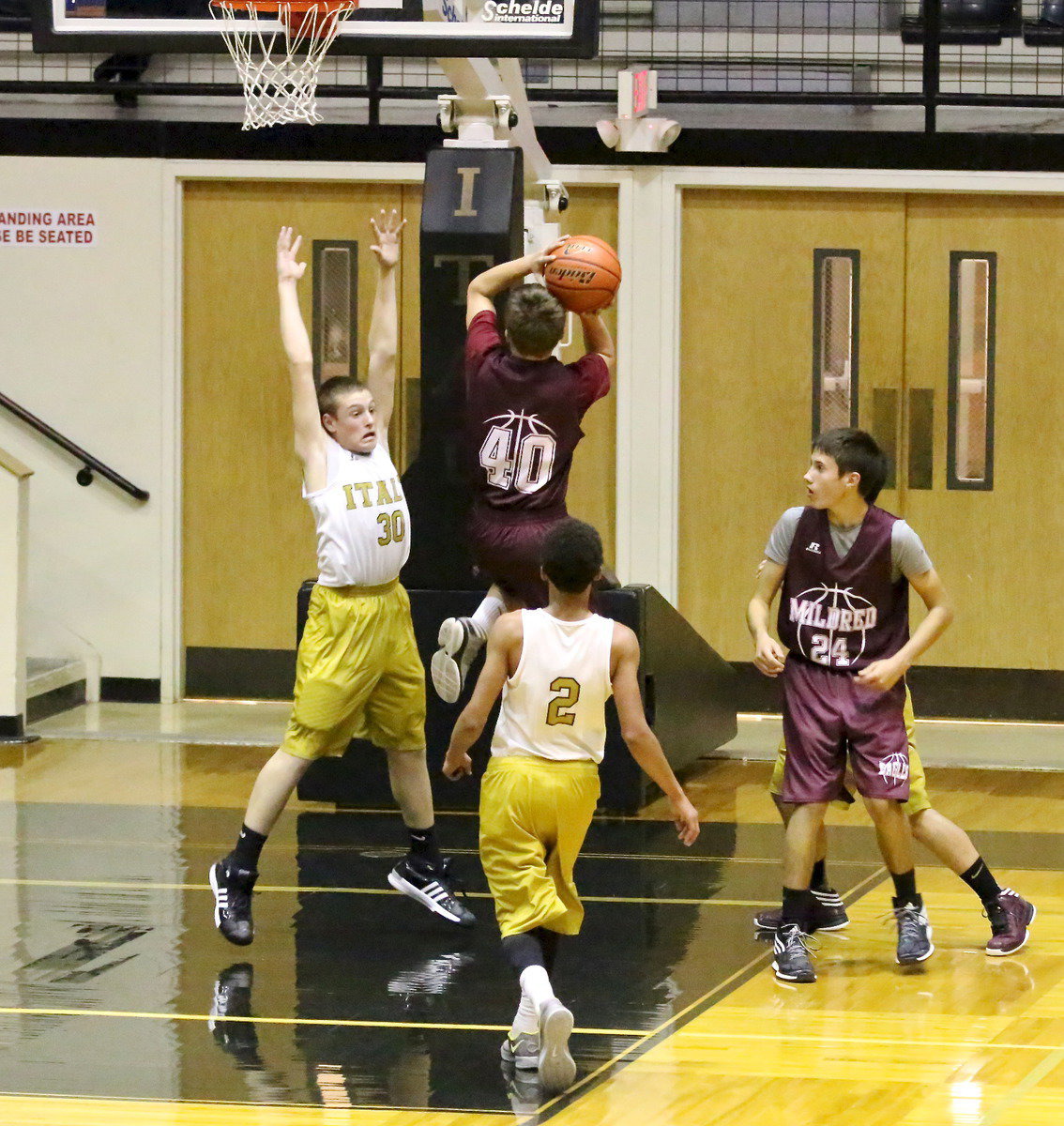 Image: Italy 8th grader Clay Riddle(30) gets big inside to ward off a Mildred shooter.