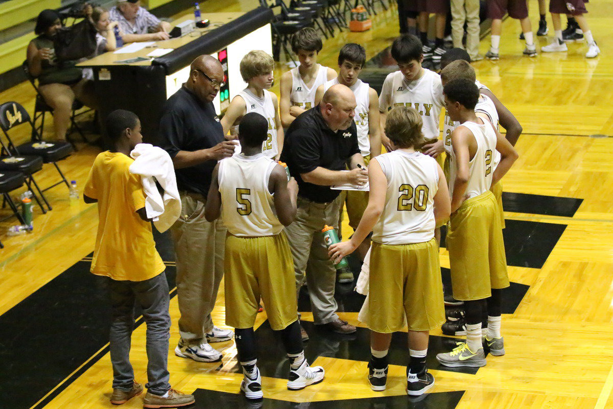 Image: 8th grade head coach Wayne Rowe talks with his players with the game on the line.