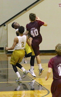 Image: Kendrick Norwood(5) draws a charging file to deny Mildred a fast break basket.