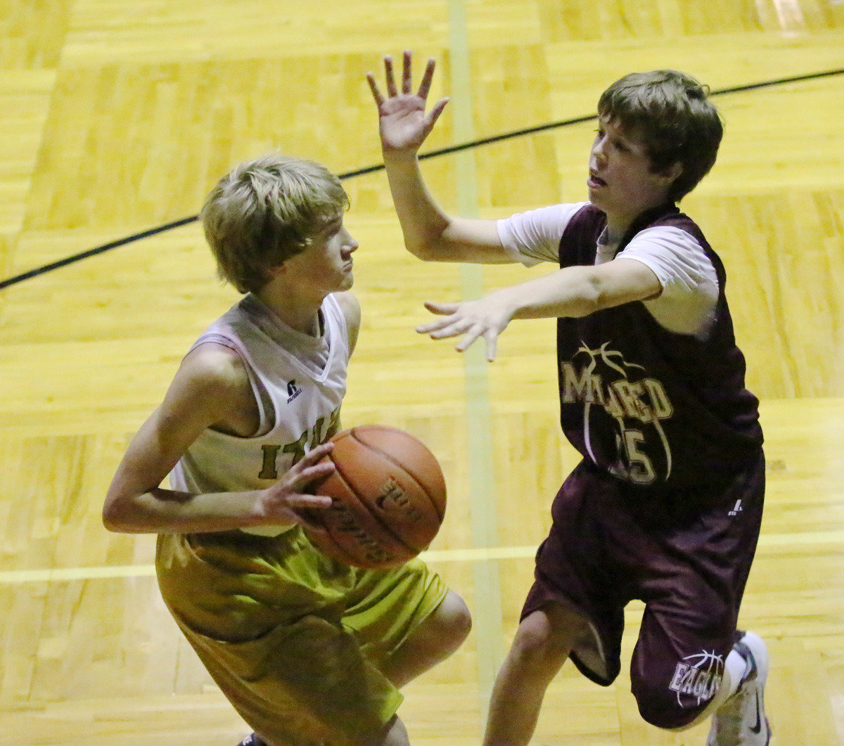 Image: Garrett Janek(12) drives the baseline.