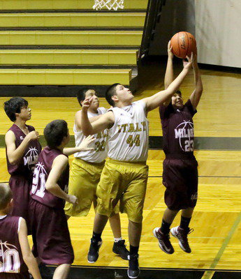 Image: Alex Garcia(44) stretches for a rebound during the 7A-team game.