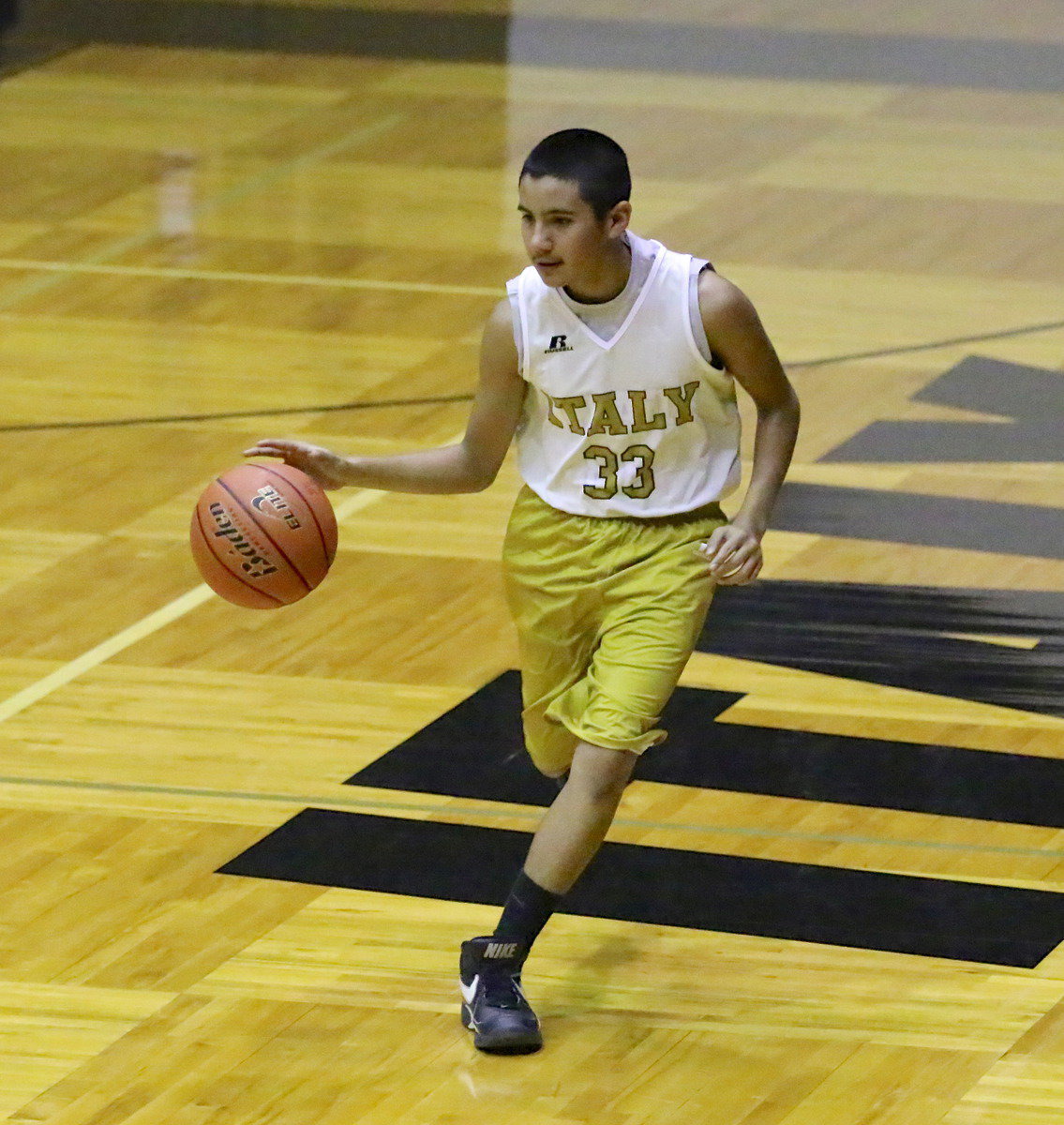 Image: Jacob Wiser(33) pushes the ball up the floor.