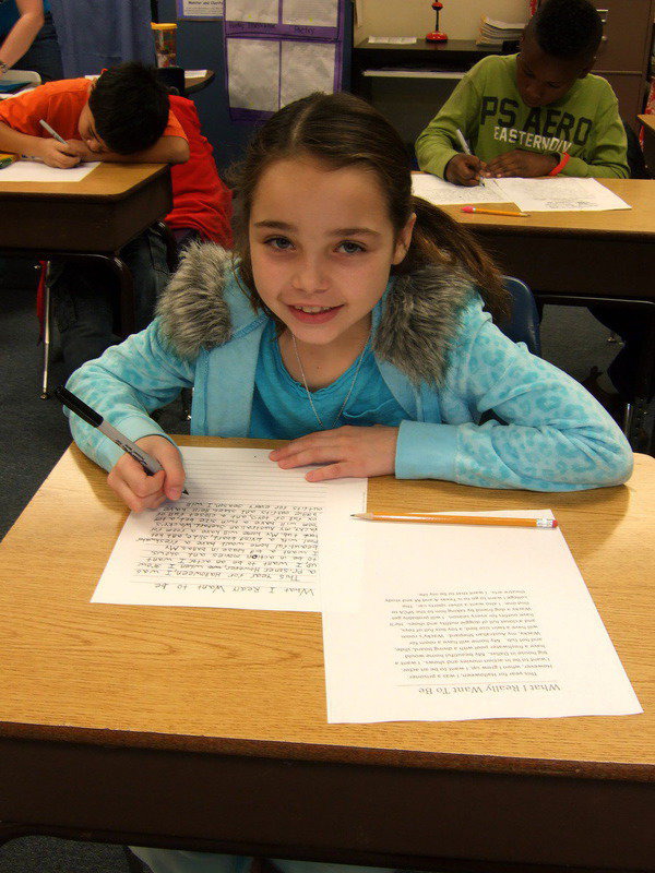 Image: Emily Janek is busy writing a story for her book.