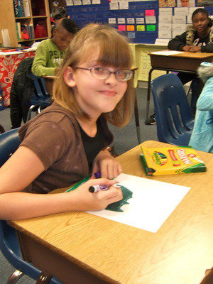 Image: Kinsey Whatley doing some illustration for her class book.
