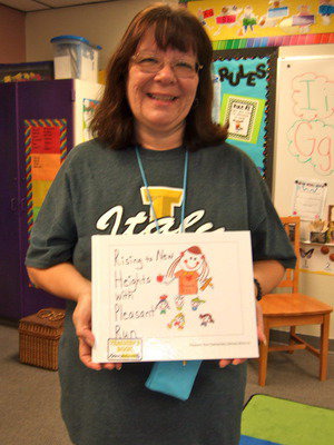 Image: Miss Mendoza holds a finished published book.