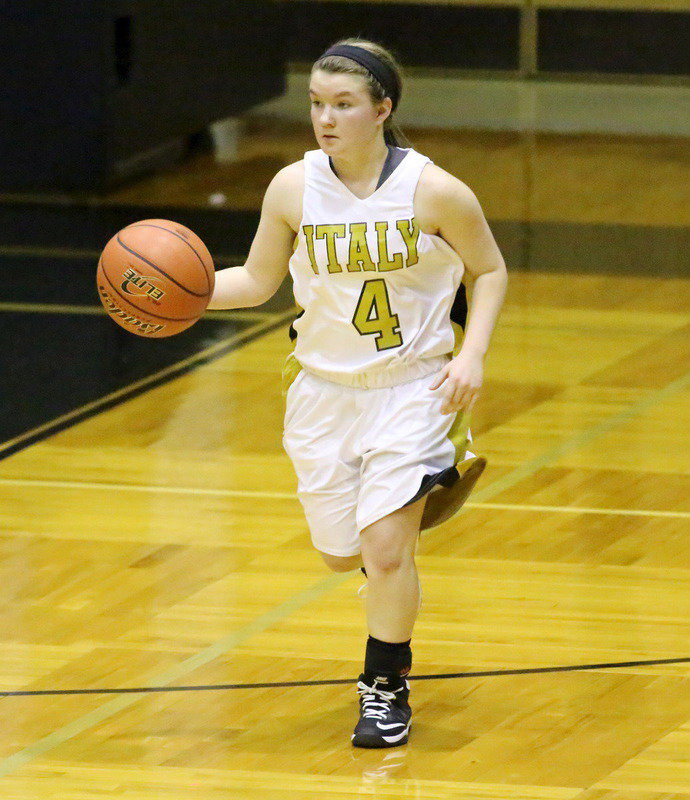 Image: Guard Tara Wallis(4) hurries the ball up the court.