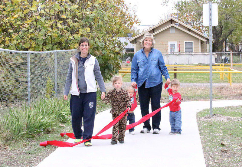 Image: Sophia Creighton and her daughter, Alex, try out the new walking trail with Ann Hyles and her grandsons, Tucker and Trip Russ.