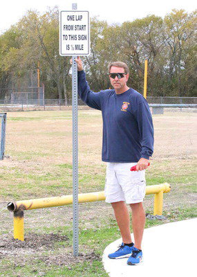Image: Charles Hyles points out the lap markers. Whether you start the trail clockwise or counterclockwise, each direction has a sign installed for convenience.