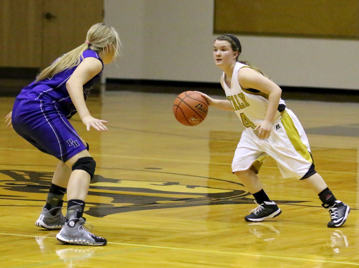 Image: Tara Wallis(4) brings the ball up against a Peaster defender.