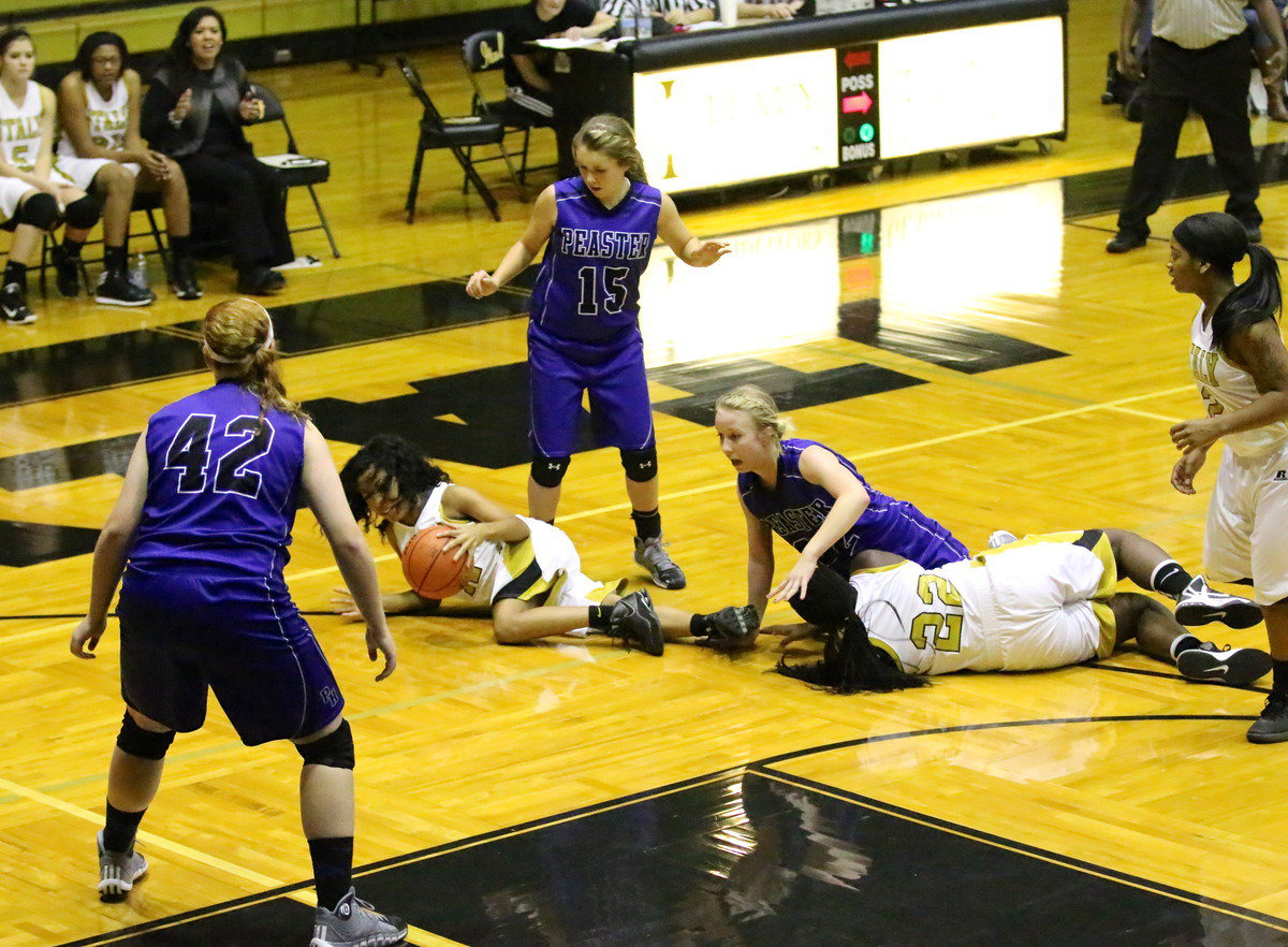 Image: Ryisha Copleland(11) and teammate Taleyia Wilson(22) fight for a loose ball.