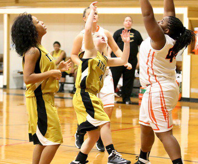 Image: Tara Wallis(4) plays big in the paint as teammate Ryisha Copeland(11) looks to get the rebound.