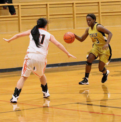 Image: Kortnei Johnson(3) crosses over her dribble to get a shot up from the lane.