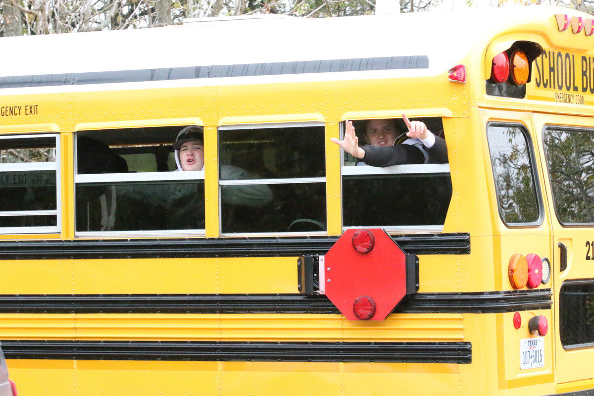 Image: Gladiators Tyler Vencill, Bailey Walton and Kyle Fortenberry wave to their supporters as they prepare to take on Collinsville.