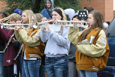 Image: Gladiator Regiment Band members Garrett Janek, Annie Perry, Kirby Nelson, Madison Washington and Amber Hooker play loud and proud as the team bus leaves for the game.