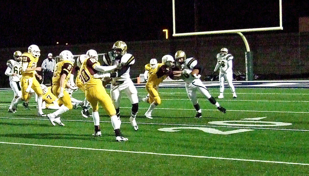 Image: Senior receiver Tre Robertson(3) leads the way for running back Coby Bland(40).