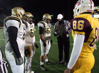 Image: Senior captains Kevin Roldan(60), Darol Mayberry(58) and Zain Byers(50) represent the Gladiators during the pre-game coin flip.