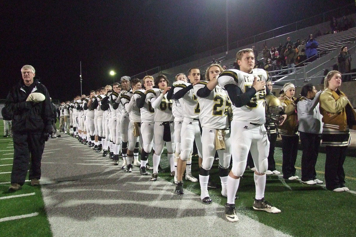 Image: Head coach Charles Tindol stands with his players and the cheerleaders ready to take on the Pirates of Collinsville for the area championship.