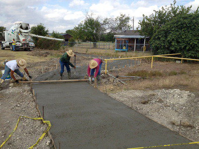 Image: A photo from the construction of the trail shows the concrete being poured and smoothed.