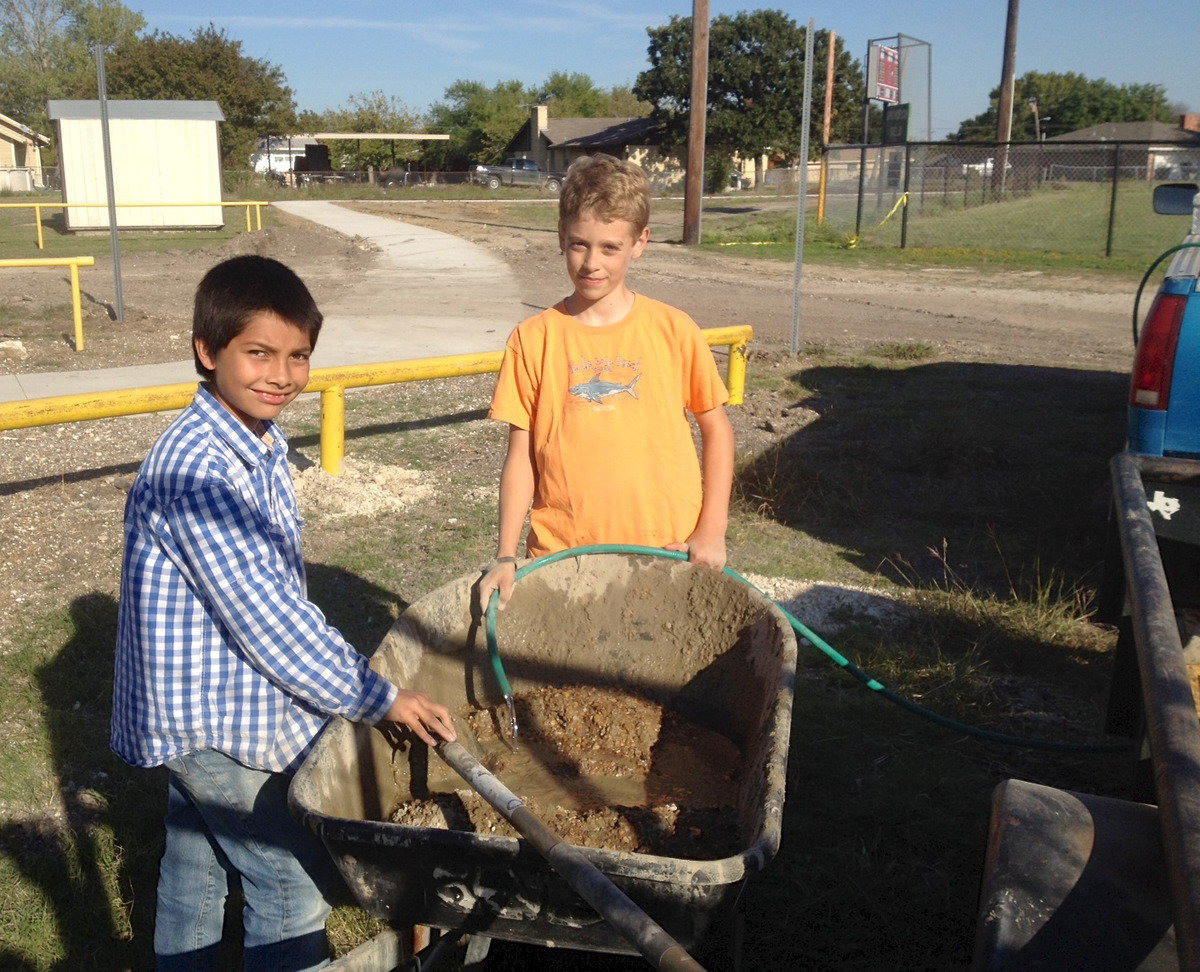 Image: Jose Luna and Creighton Hyles prepare to install posts into the ground that will follow parts of the trail.