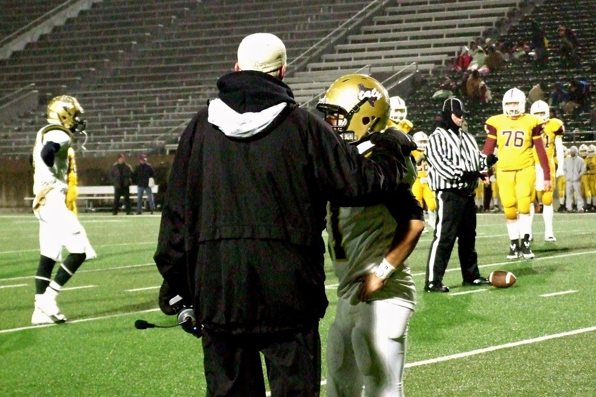 Image: Coach Tindol sends in a play with backup senior quarterback Tyler Anderson(11) who fills in for an injured TaMarcus Sheppard.