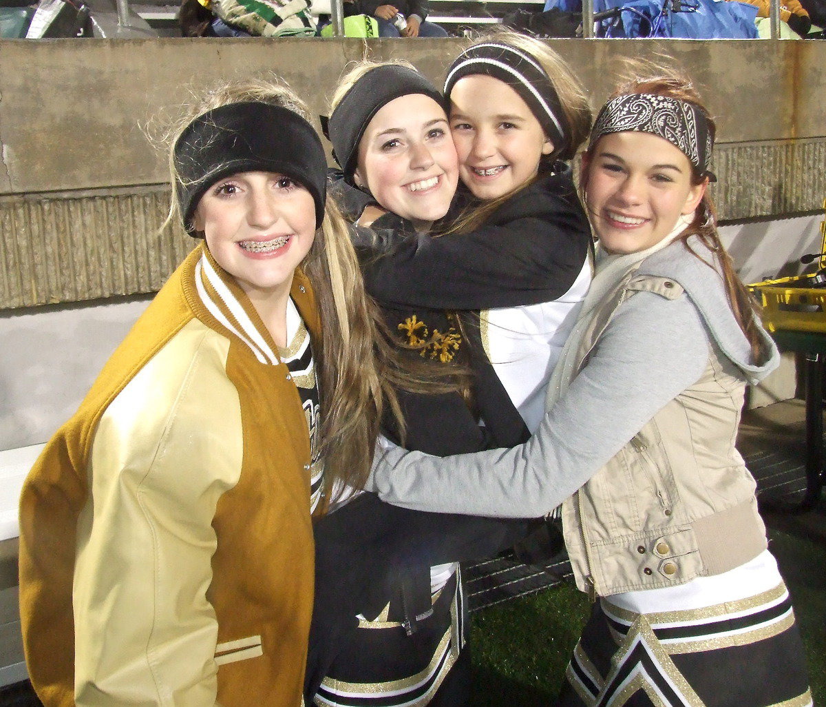 Image: Cheerleaders Kirby Nelson, Kelsy Nelson, Karley Nelson and Kristian Weeks are excited before the start of the game.