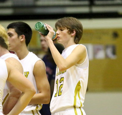 Image: Ty Windham(12) takes in some fluids after being Italy’s high-point man in the third period against Madisonville. Windham scored 3-points the old fashioned way.