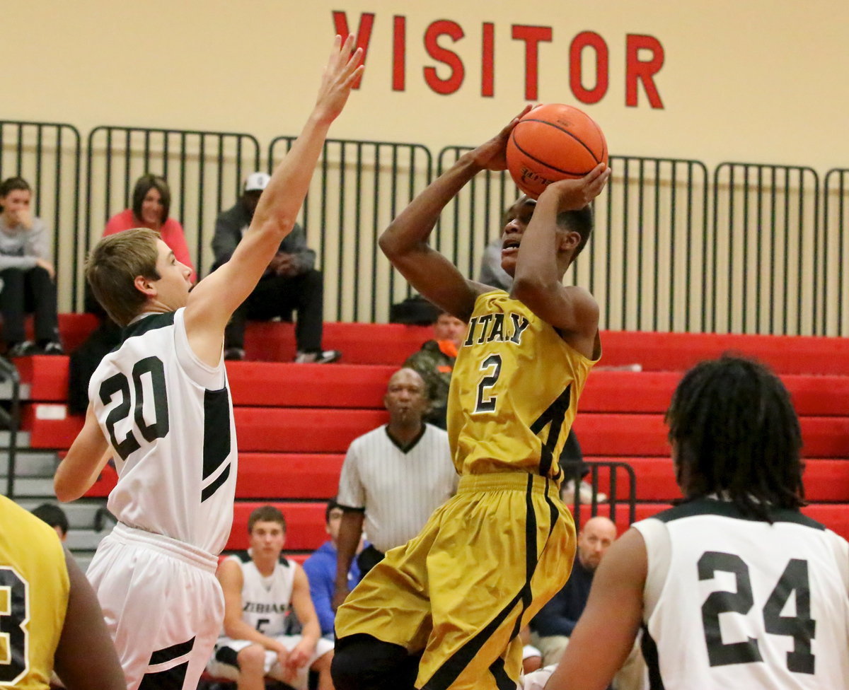 Image: Trevon Robertson(2) rises for a shot over a  Zebra defender to help Italy overtake Grandview for a 49-43 win in the  first-round of the West High School hosted basketball tournament.