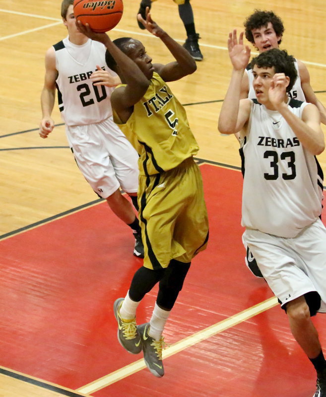 Image: Finishing the fast-break is Italy’s Kevin Johnson(5).