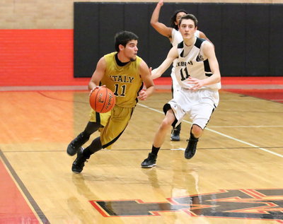 Image: Point guard Tyler Anderson(11) dribbles past Zabra defenders.